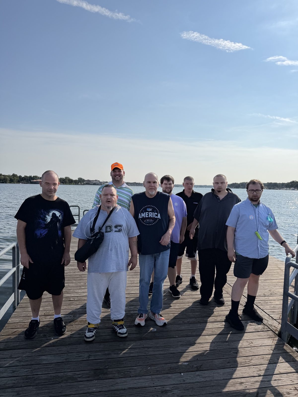 Giddings AFC residents and staff enjoying a sunny day together on a waterfront dock