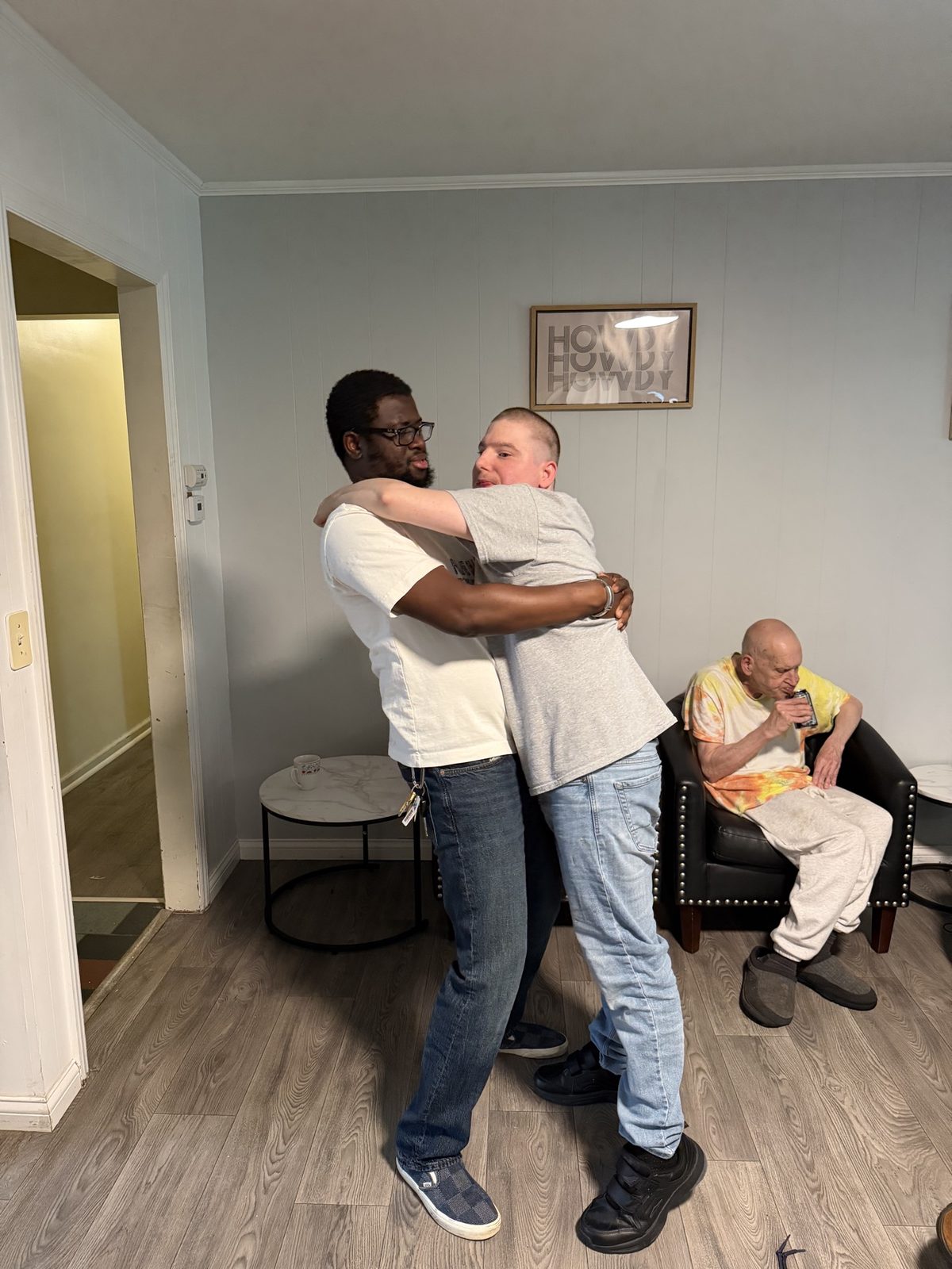 Two members of the Giddings community sharing a hug