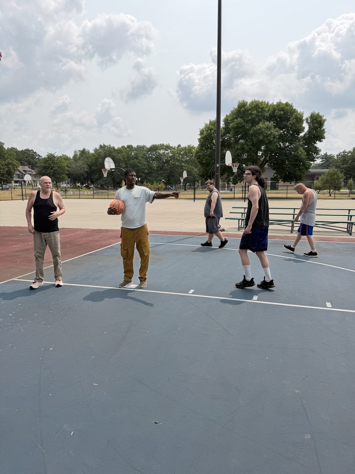 A group playing basketball outside
