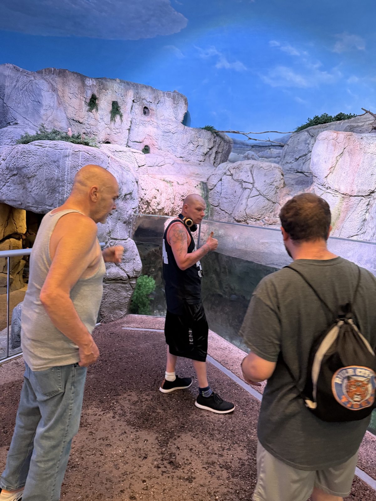 A group exploring an indoor animal exhibit
