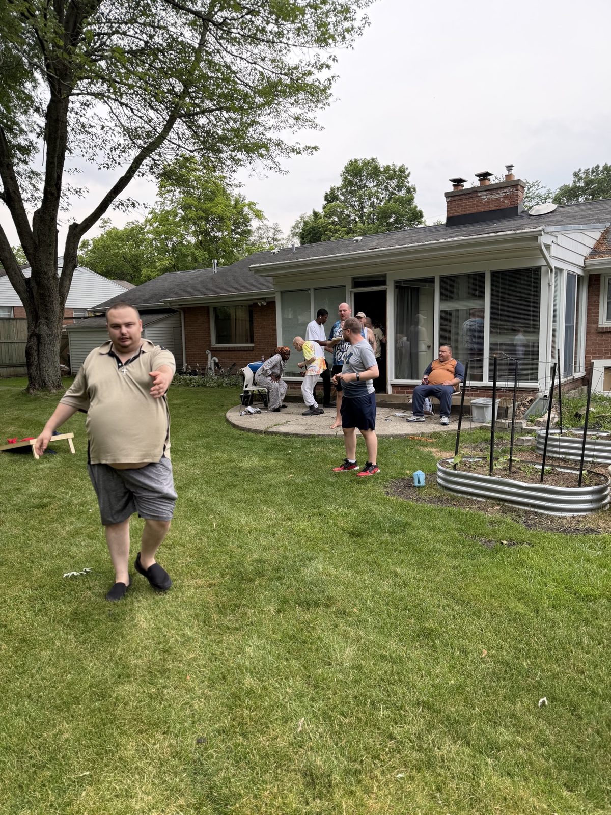 Residents and staff spending time together in a backyard