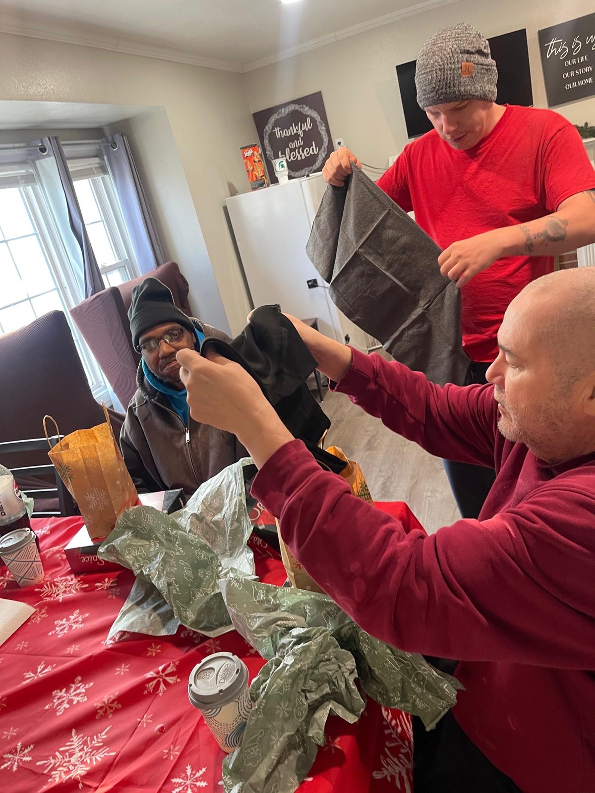 A Giddings AFC resident opening a Christmas gift