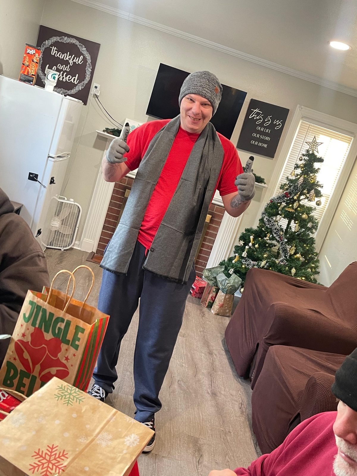 A Giddings AFC resident wearing a scarf and giving a thumbs-up